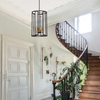 Pendant lighting beside a curved staircase